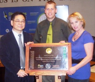 Richmond Councillor Chak Au, left, with Michael Wolfe and Carol Day, posing with an international award they had a part in bringing to Richmond — from IESCO, a UN affiliate.