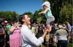 Justin Trudeau balancing a baby on one hand. Vancouver Sun photo.